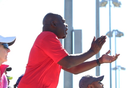 Kevin Sims cheering on players on the court