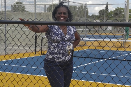 Mary McCoy proudly shows off the newly installed 36 ft. courts