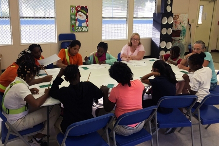 Peg Perez working with students in the classroom