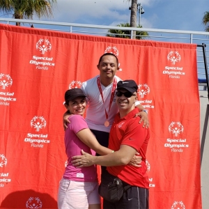Santiago with his mother and stepfather at the 2019 Special Olympic State Games