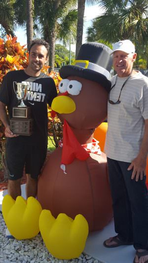 THE DIRECTOR & THE STAR: Tournament director Keith Dunlop (l.) and men's open winner Eric Prodon sandwich the turkey that is the event's mascot.
