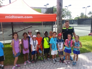 NOT JUST KIDS' STUFF: The first, second, and third place finishers (front row) in the 10 and under and eight and under events are wearing medals.  Sean is the tall guy.